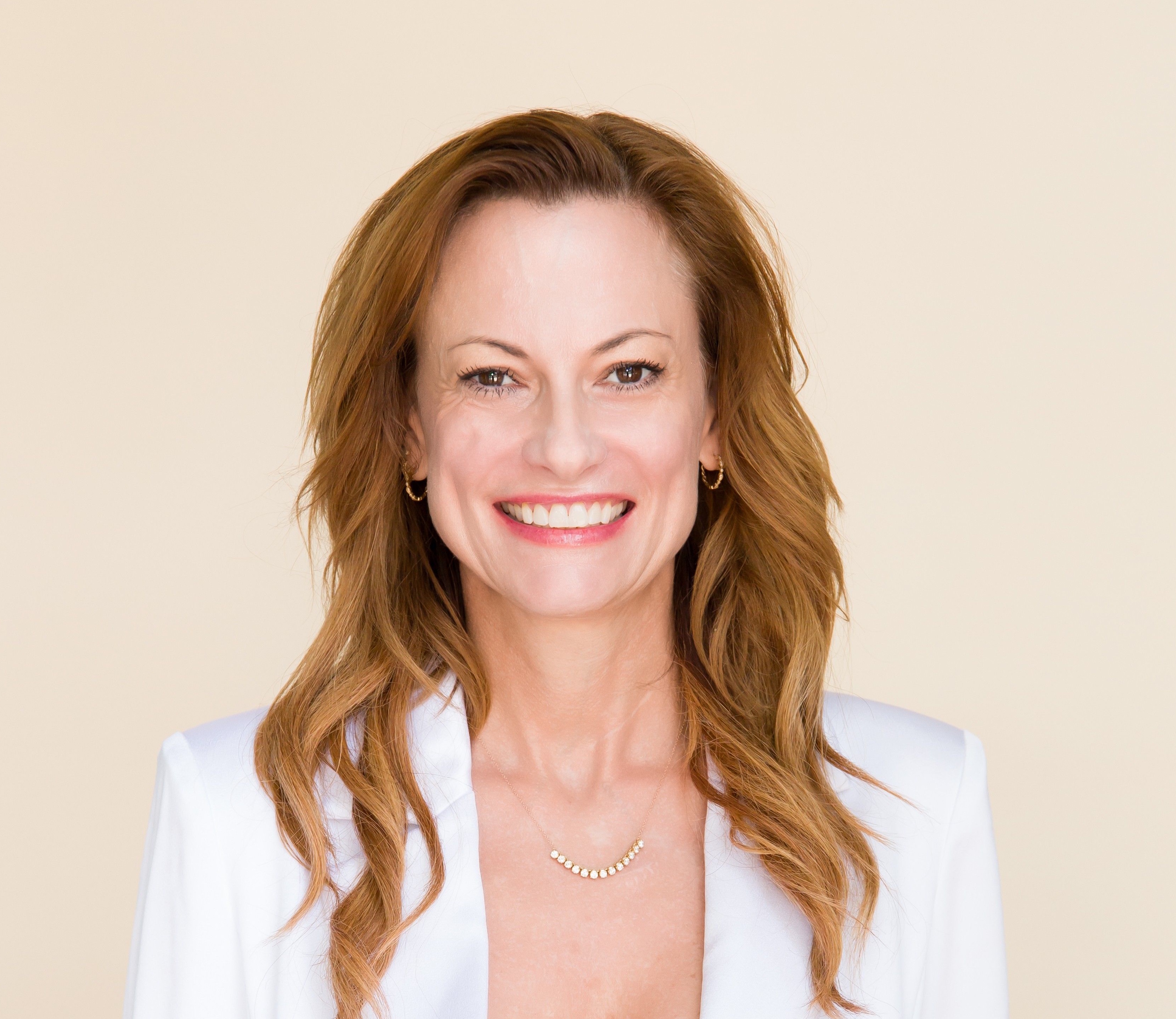 Molly Anderson smiling in a white jacket